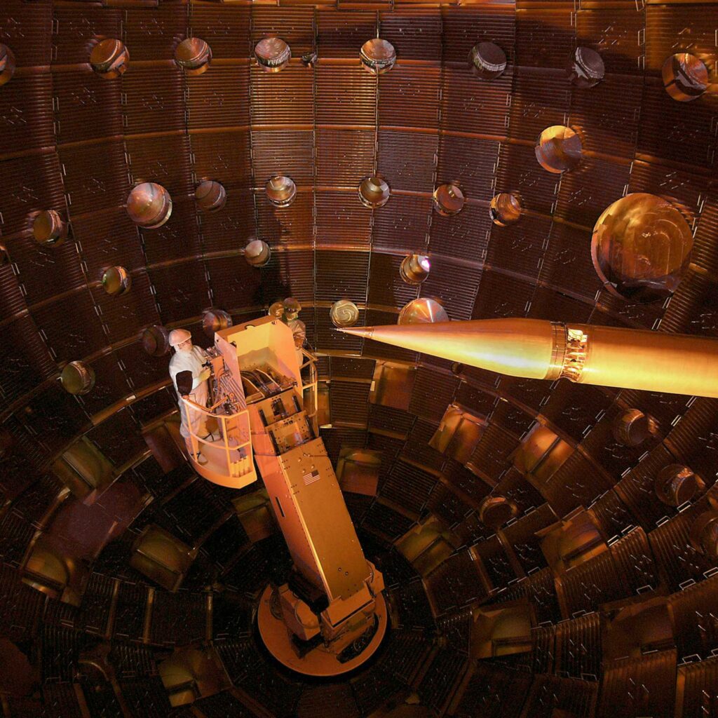 A worker performing service on a manlift in a nuclear environment at NIF Target Chamber