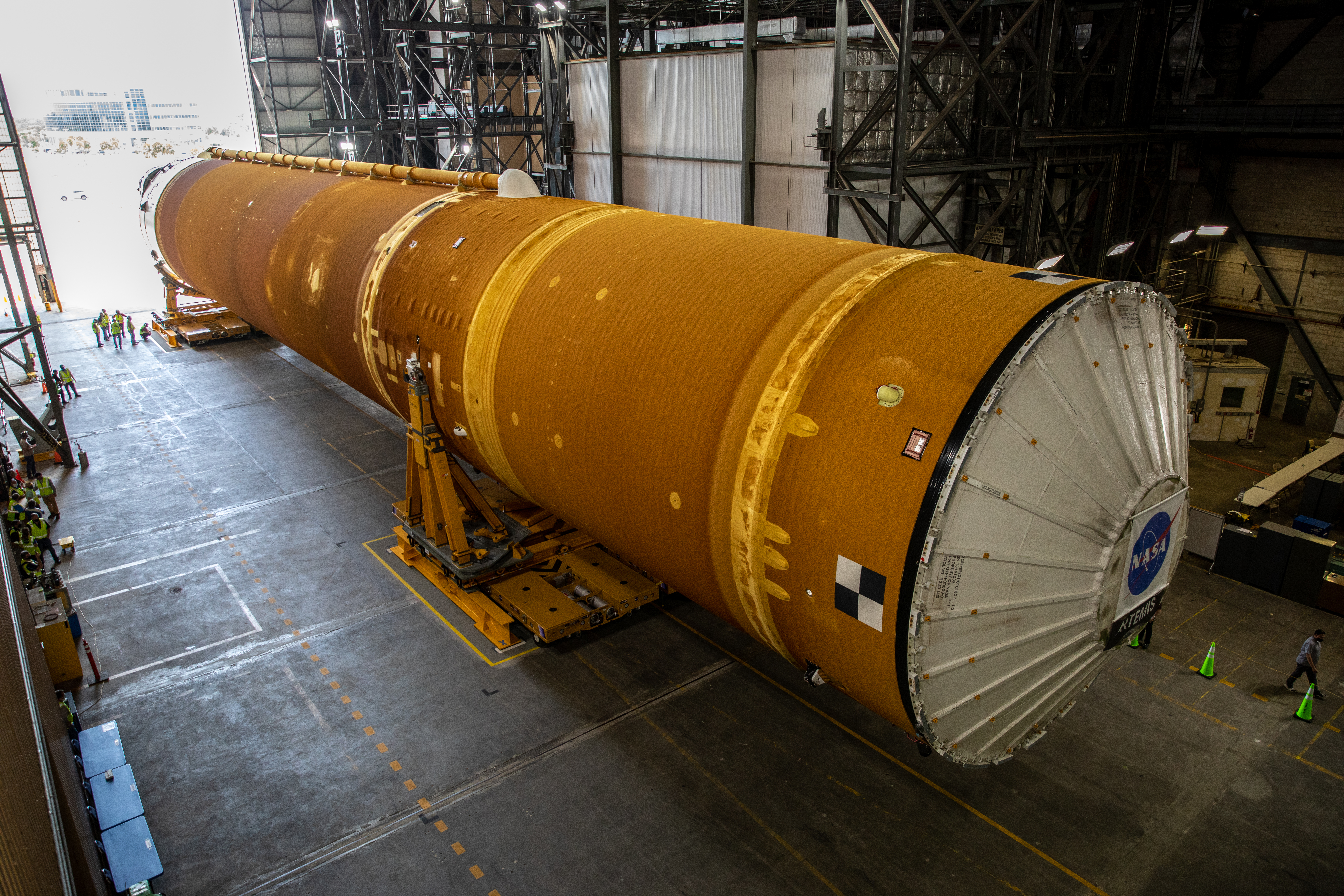 The core stage of NASA's Artemis rocket being offloaded to the vehicle assembly building