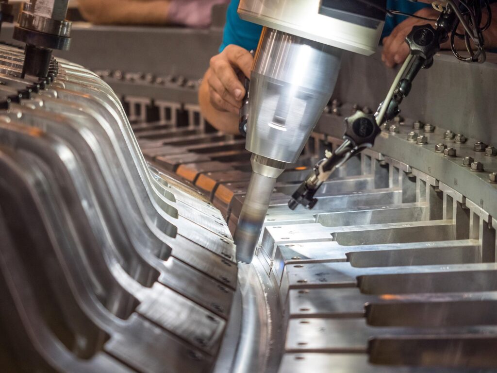 Technicians inspecting circumferential friction stir welding process