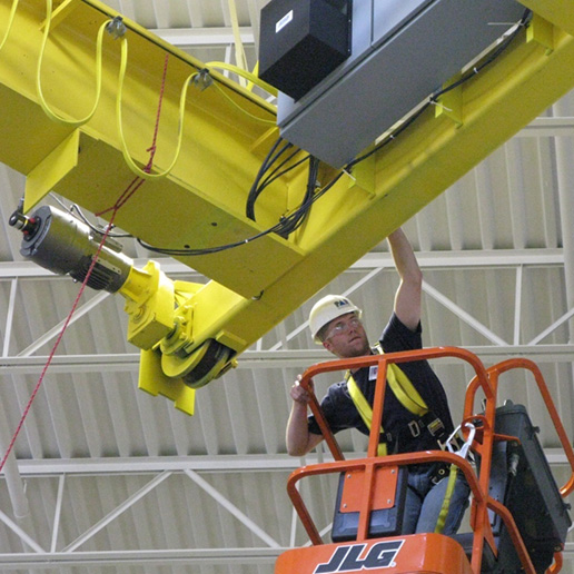 Crane operator servicing crane on a TensileTruss Platform.