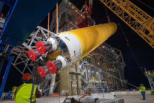 SLS Rocket core stage being lifted by specialty cranes