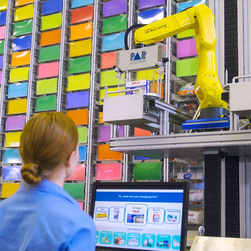 PAR engineering team member standing in front of a configurable, robotic fixture.